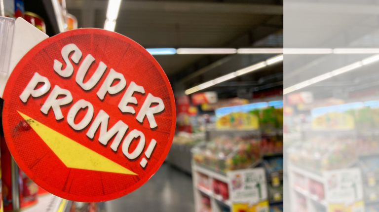 Red circular promo sign with a yellow stripe, reading 'SUPER PROMO!' in a supermarket aisle